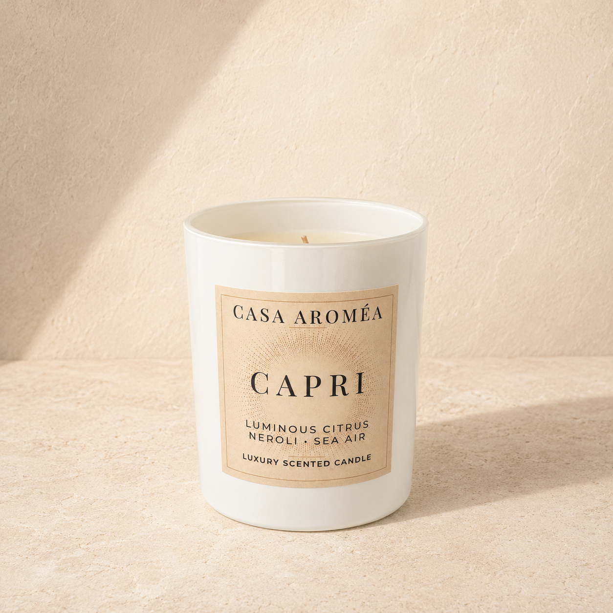 Large Capri scented candle by Casa Aroméa in a white glass vessel against a warm Mediterranean-inspired textured background