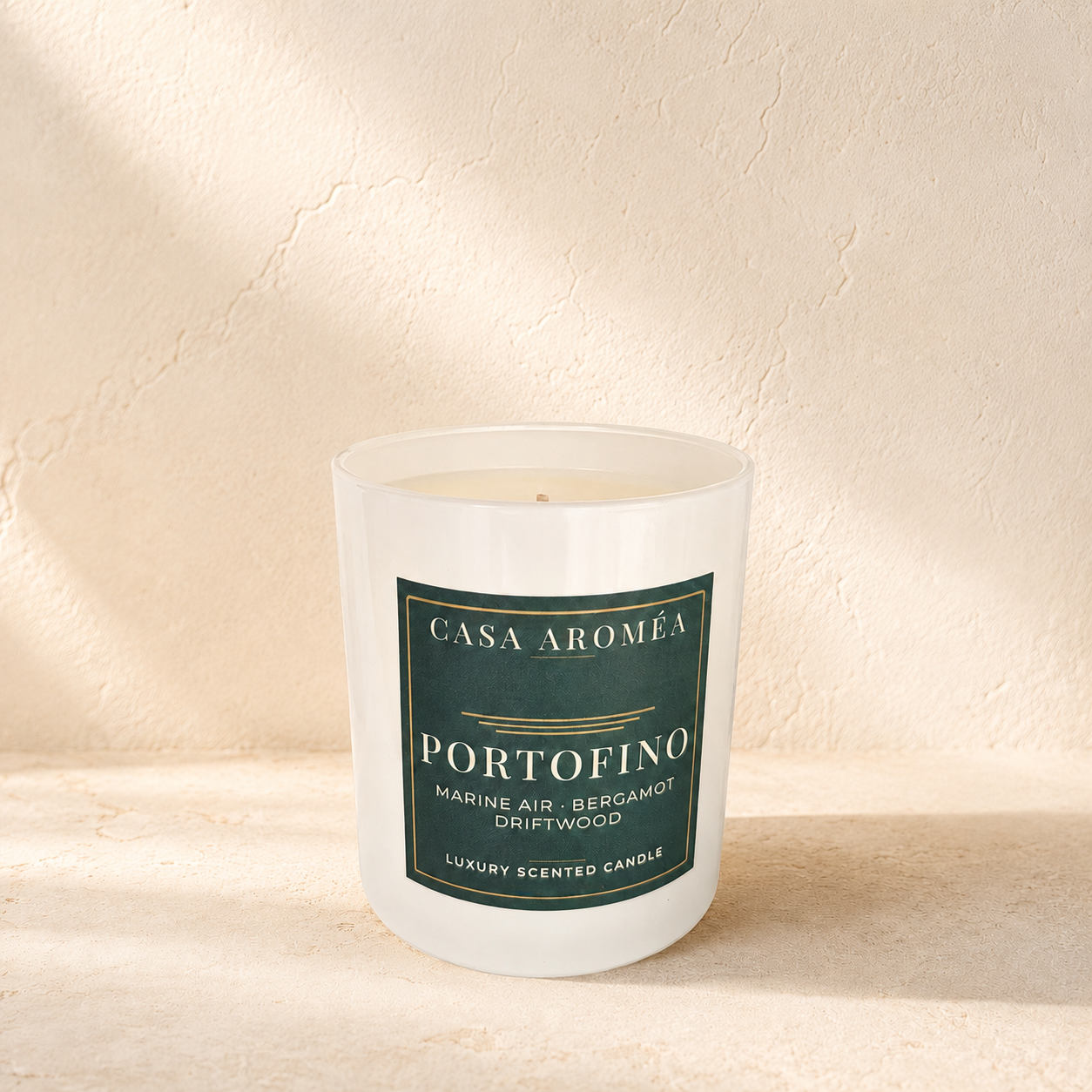 Large Portofino scented candle by Casa Aroméa in a white glass vessel against a warm Mediterranean-inspired textured background