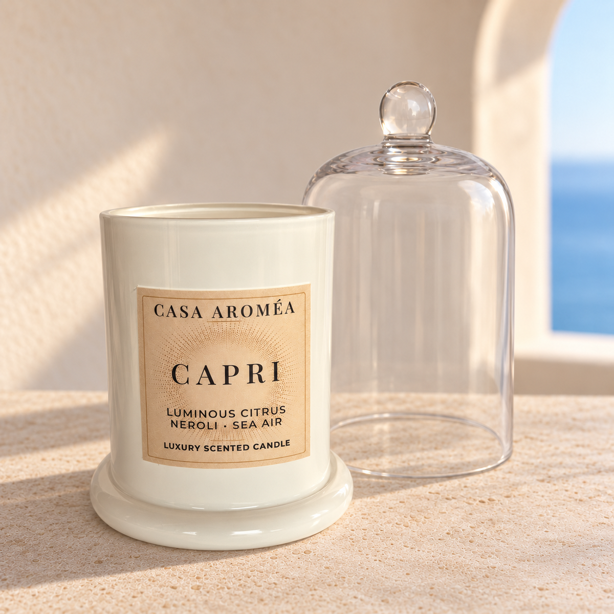 Casa Aroméa Capri candle in an ivory vessel on a matching base, with the glass cloche beside it.